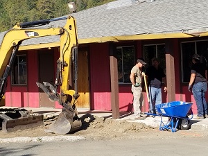 A picture of the excavator working outside of the main building